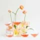 glasses of rosé wine among a small display of spring flowers on a white backdrop